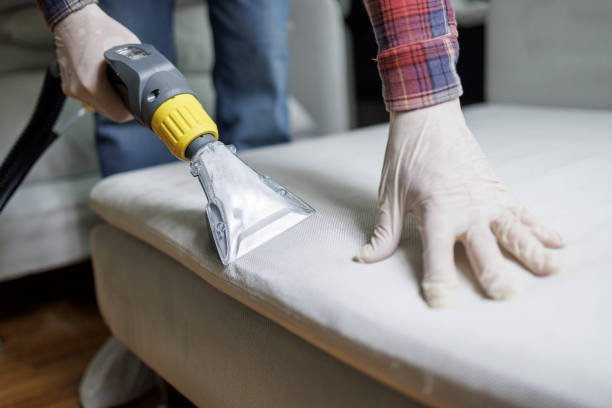 Home dry cleaning of furniture. specialist vacuum cleaning the couch.